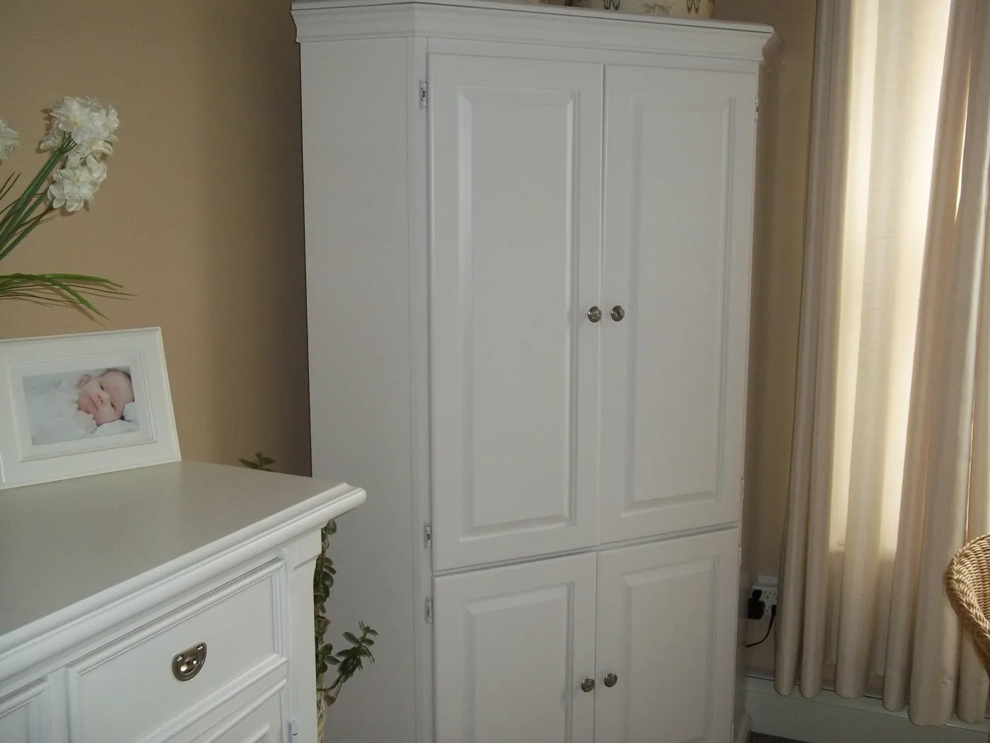 White painted custom cabinet with raised panel doors
