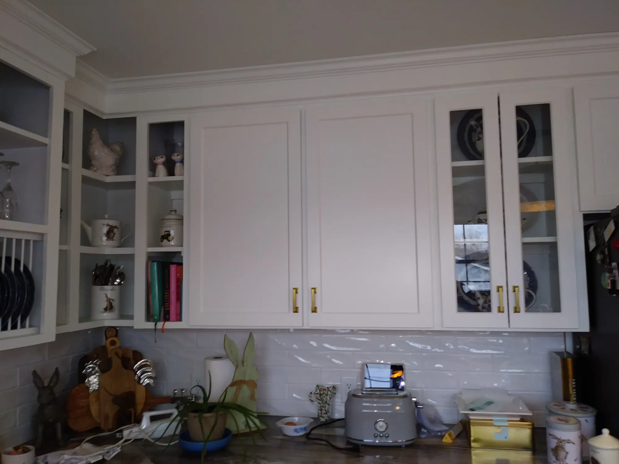 Refaced white kitchen cabinets with glass doors